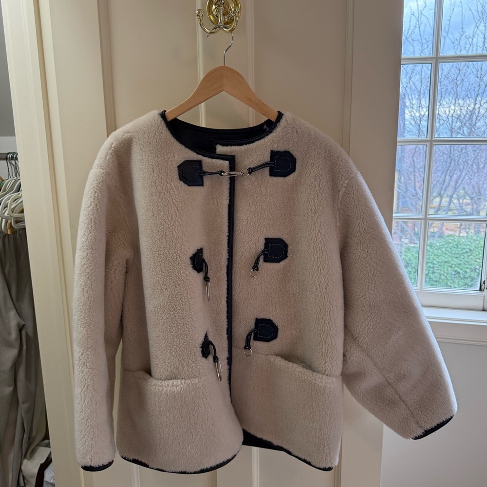 We Are faux shearling jacket. 30% wool and 70% poly. Very warm.